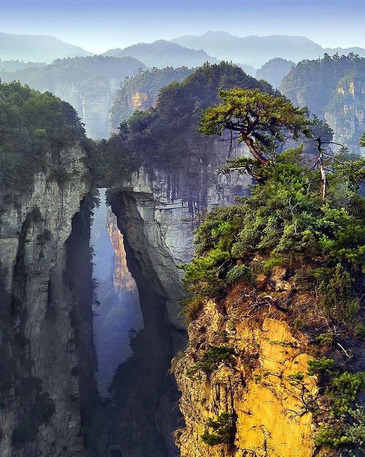 A stone bridge spanning a misty canyon