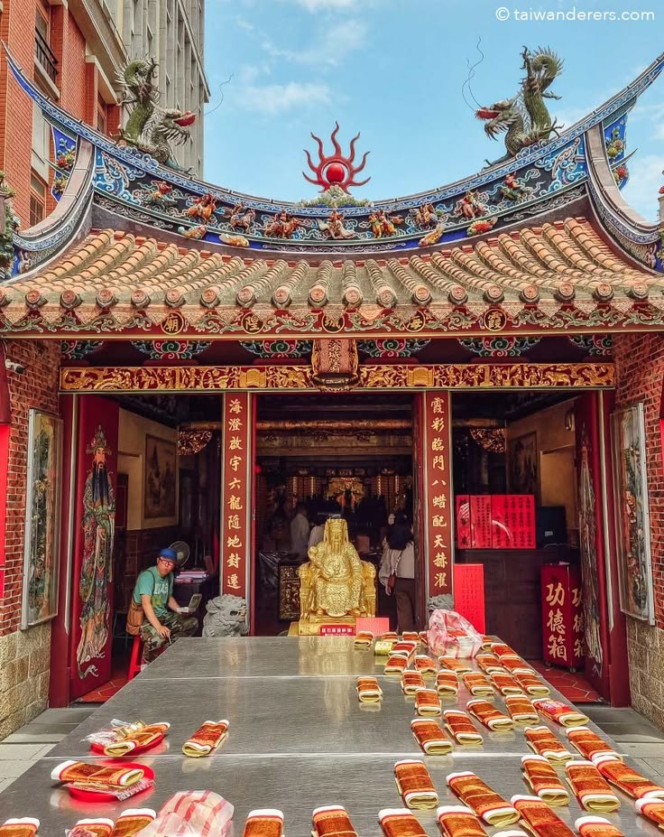 Ornate red and gold temple altar with offerings