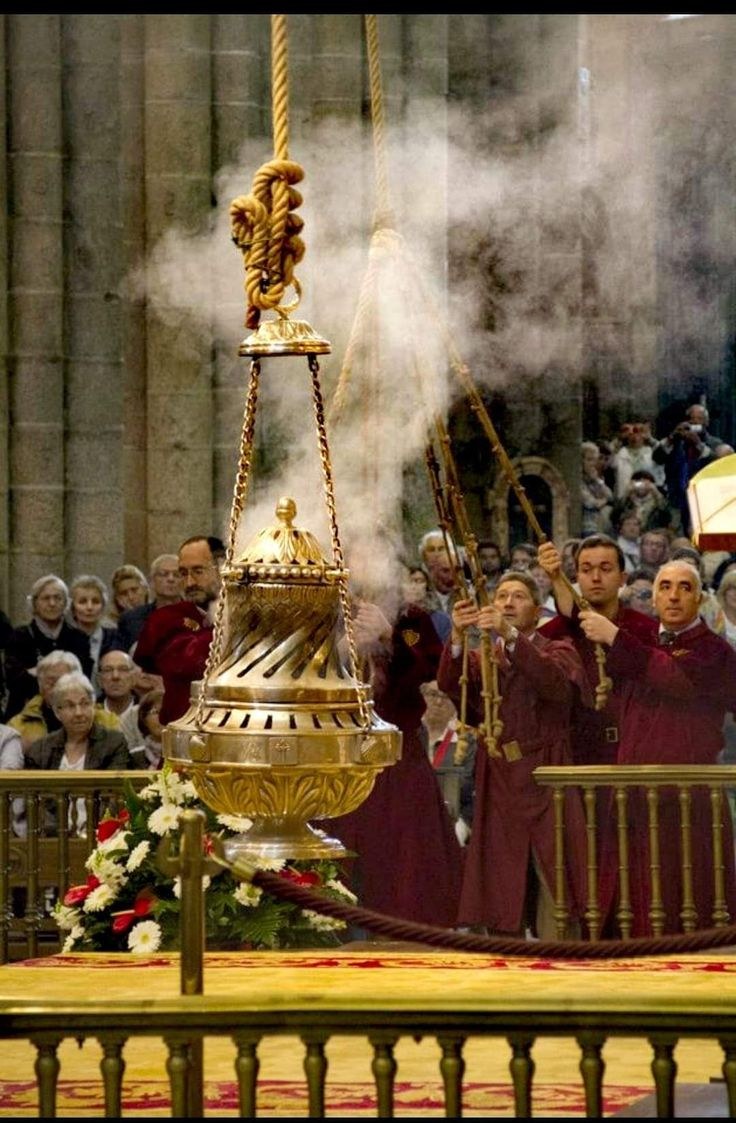 A large ceremonial censer at the center of a gathered assembly