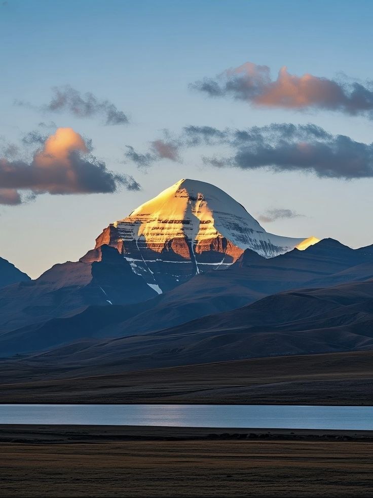 The snow pyramid of Mount Kailash reflected in still water