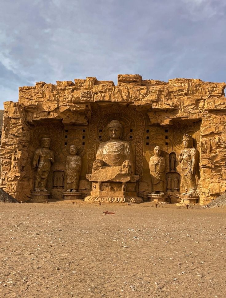 Buddha figures carved directly into a rock cliff face